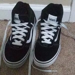 Black and white hightop Vans